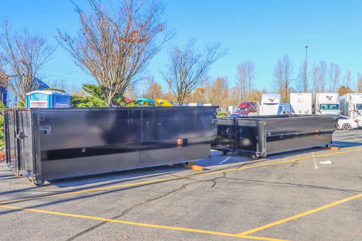 Professional dumpster rental service with roll-off container on residential driveway in Moreno Valley